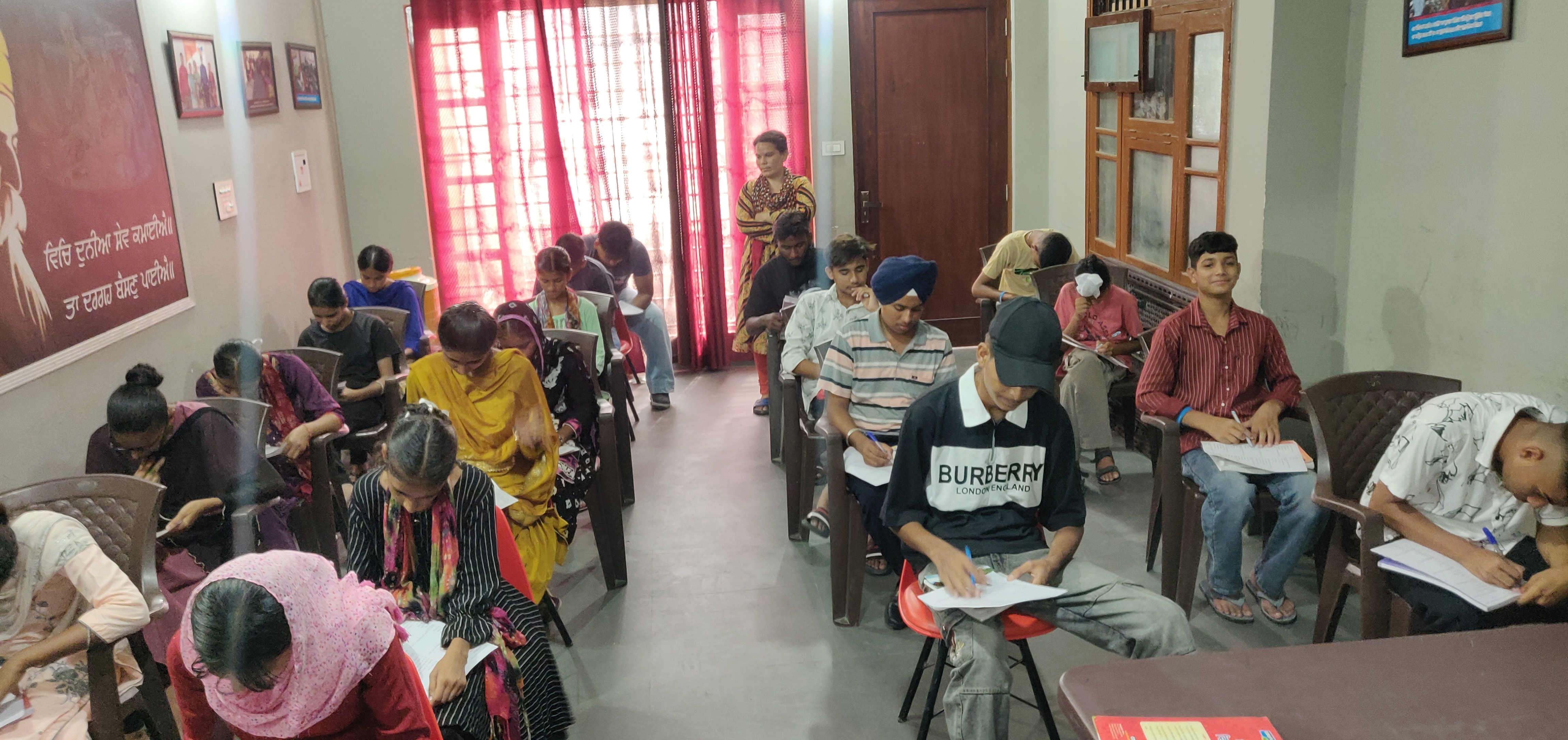 Volunteer teacher smiling in a rural classroom